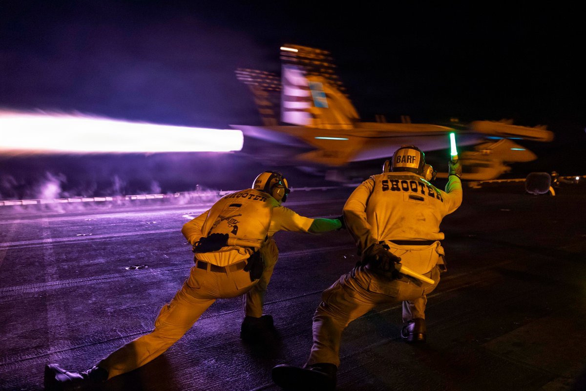 An E/A-18G aircraft launches from the flight deck of USS George H.W. Bush (CVN 77) during night flight operations while the ship supports enforcement of the U.S. blockade against Iran in the Arabian Sea. As of Sept. 7, CENTCOM forces have redirected 94 commercial vessels, disabled 3 and boarded 2 to ensure complete compliance with the blockade.