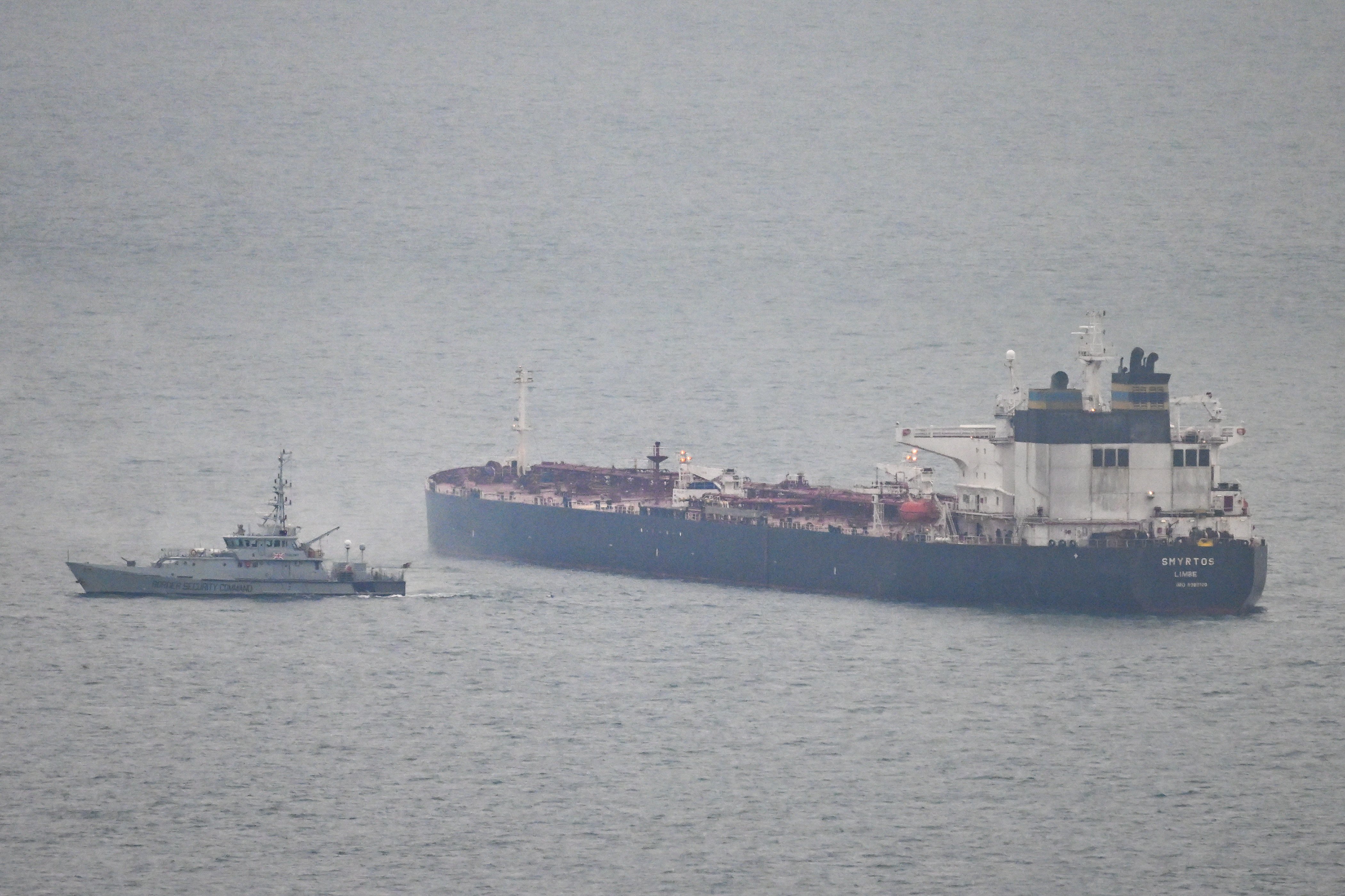 PORTLAND, ENGLAND - JUNE 15: A border security vessel patrols the detained Smyrtos vessel outside the harbour, on June 15, 2026 in Portland, England. An oil tanker operating as part of Russia's shadow fleet has been intercepted by British Forces in the English Channel. In the early hours of Sunday morning Royal Marine Commandos and members of the National Crime Agency boarded the Smyrtos vessel, which is sailing under the flag of Cameroon. The operation is the first time the UK has intercepted a sanctioned Russian tanker, as part of efforts to disrupt Russia's funding of its war in Ukraine. (Photo by Finnbarr Webster/Getty Images)