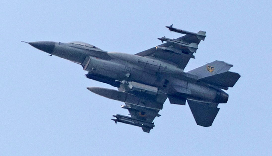 An F-16 fighter jet flies in the sky over Kyiv on August 18, 2026, amid the Russian invasion of Ukraine. (Photo by Roman PILIPEY / AFP)