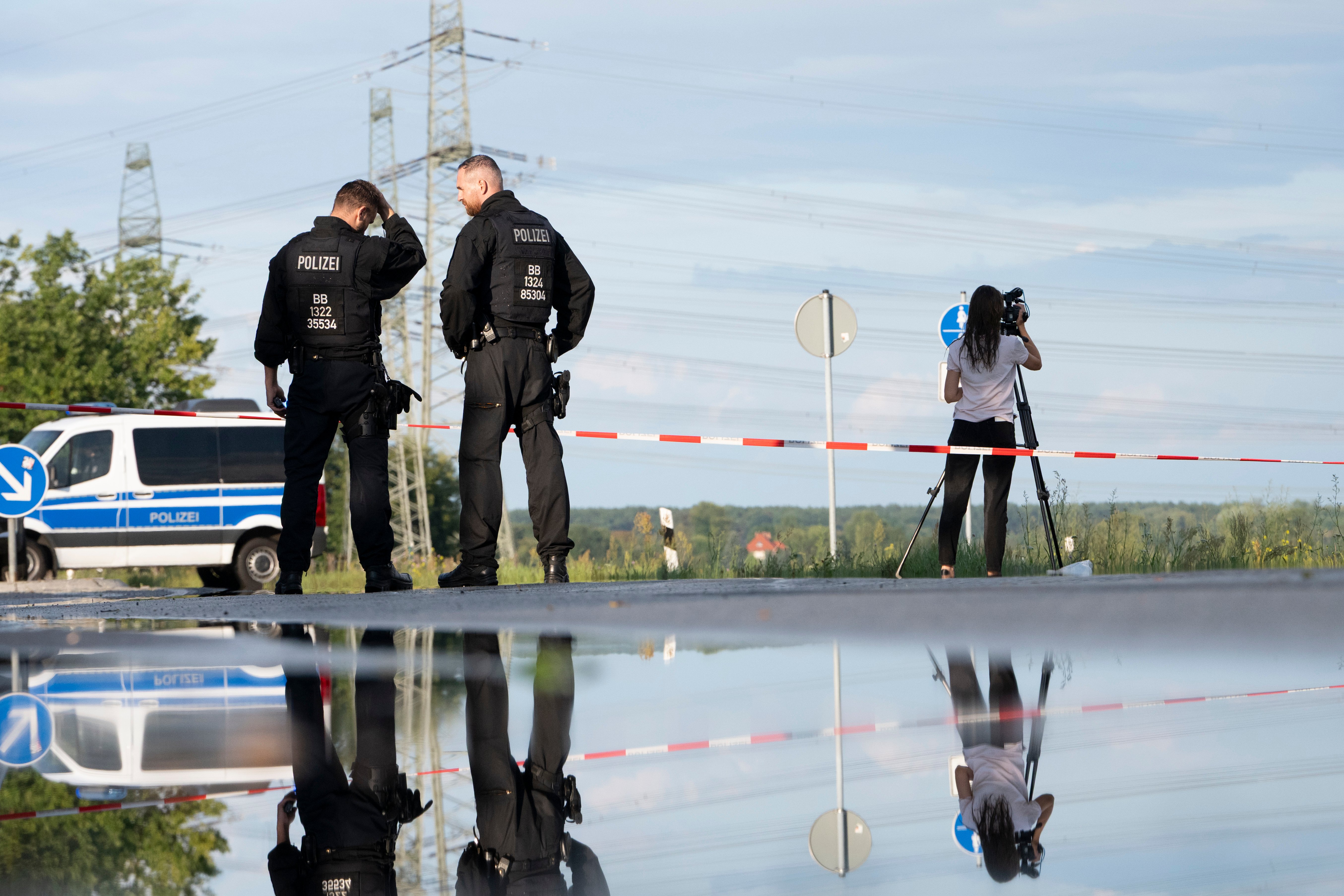 FILED - 01 September 2026, Brandenburg, Turnow-Preilack: Police officers are standing in front of a barrier. A high-voltage power line can be seen in the background. Unconventional explosive devices were found today at the nearby substation. Photo: Markus Lenhardt/dpa (Photo by Markus Lenhardt/picture alliance via Getty Images)