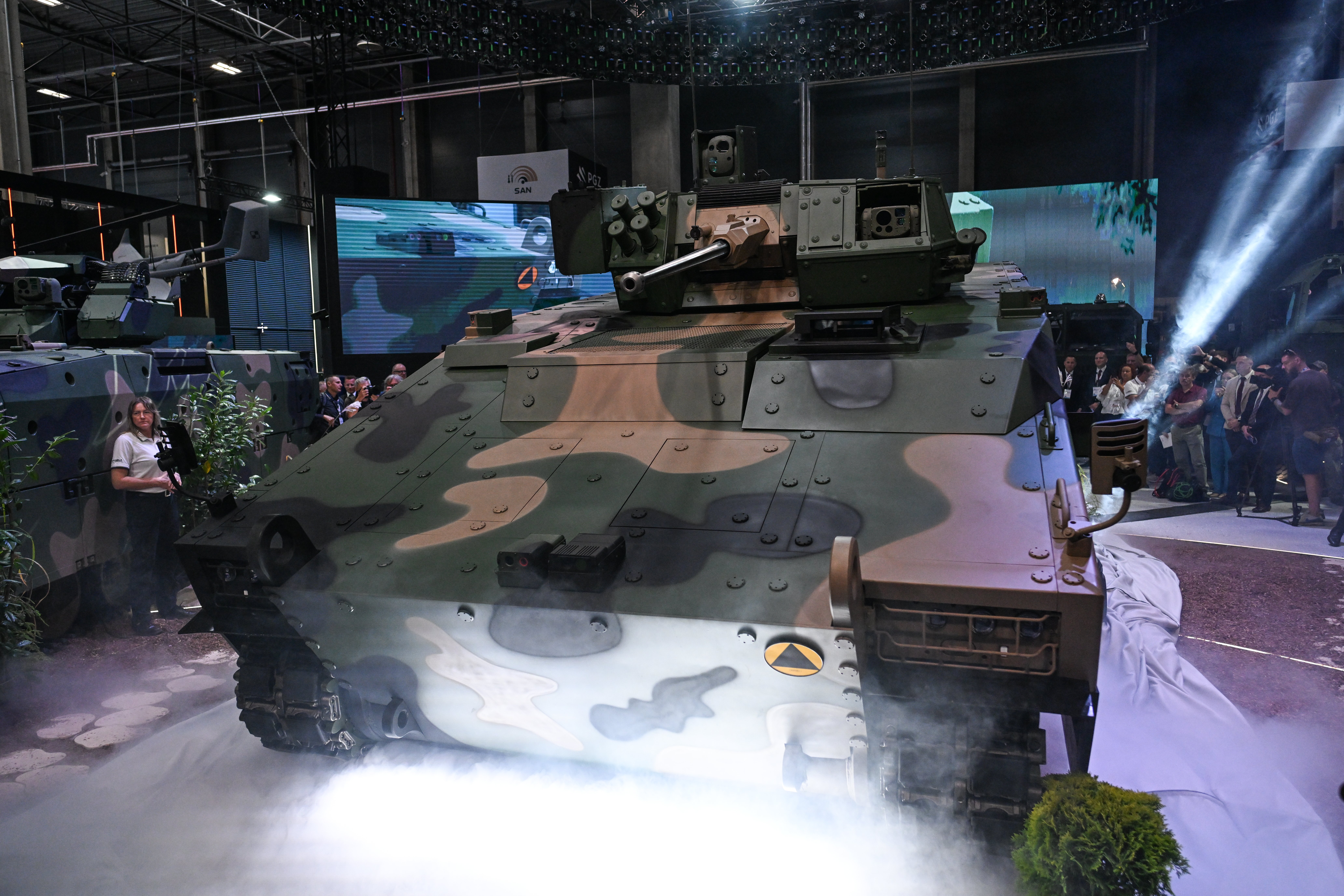 KIELCE, POLAND - SEPTEMBER 08: People attend the Premiere of Poland's PGZ Heavy Infantry Fighting Vehicle during MSPO 34th International Defence Industry Exhibition at Targi Kielce, on September 08, 2026 in Kielce, Poland. The 34th edition of MSPO (short for the Polish "Międzynarodowy Salon Przemysłu Obronnego," or "International Defence Industry Exhibition") is taking place September 8–11, 2026 in Kielce, organized in cooperation with Poland's Ministry of National Defence and this year's lead nation, Canada. The annual trade show is the largest in Central and Eastern Europe, showcasing more than 1,000 exhibitors from 40 countries. (Photo by Omar Marques/Getty Images)