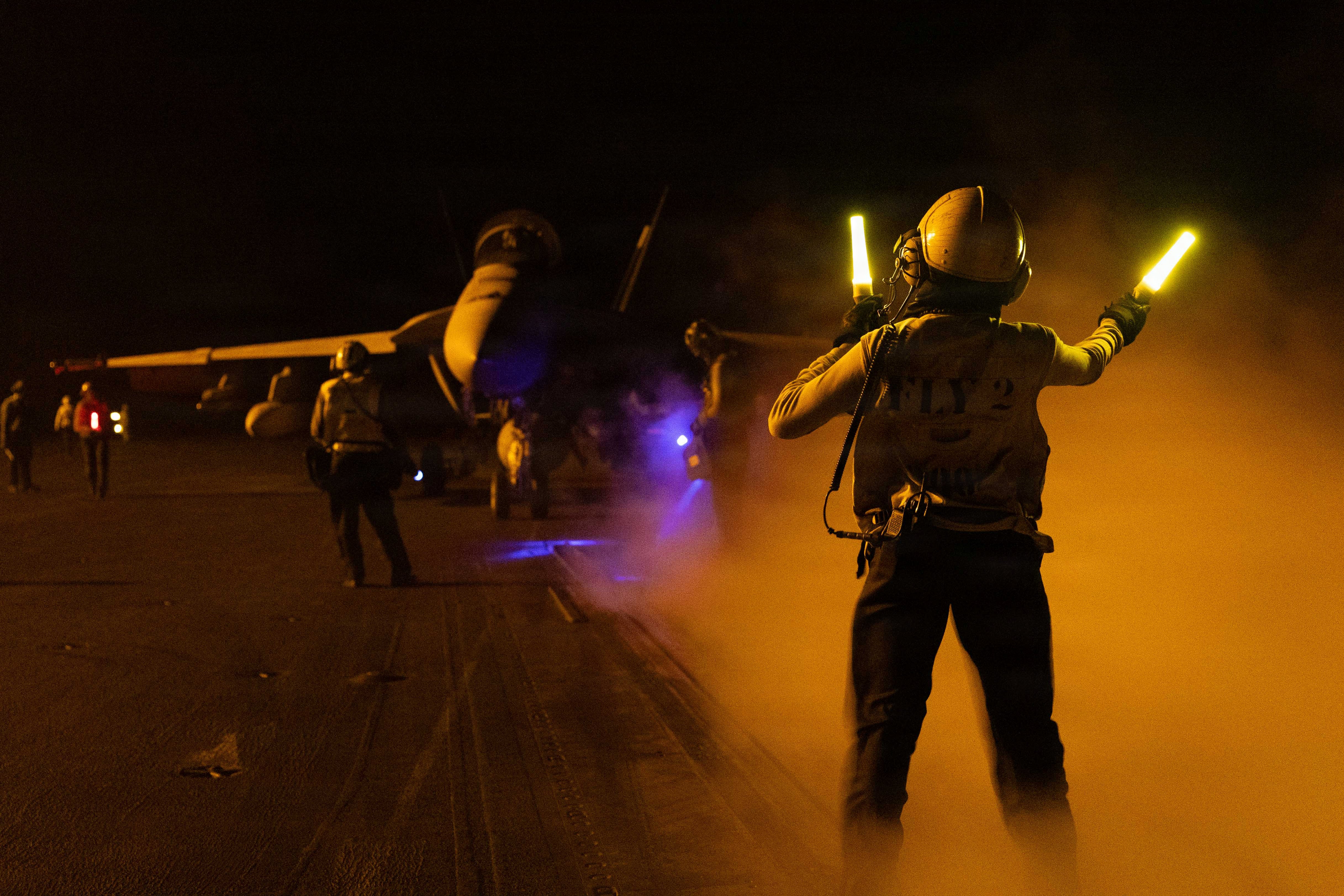 A U.S. Sailor signals an F/A-18F Super Hornet, attached to Strike Fighter Squadron (VFA) 103, on the flight deck of Nimitz-class aircraft carrier USS George H.W. Bush (CVN 77), Sept. 1, 2026. George H.W. Bush is deployed to the U.S. 5th Fleet area of operations to support maritime security and stability in the Middle East. (U.S. Navy photo)