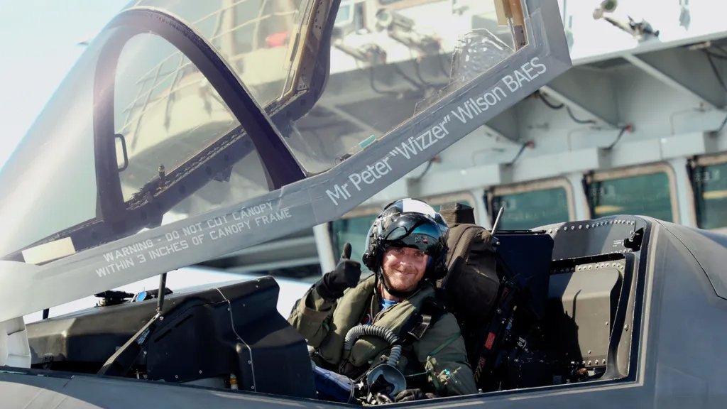 (Pictured: Royal Navy Commander, Nathan Gray in his F35B gives a celebratory thumbs up after succesfully landing onboard) Two F-35B Lightning II fighter jets have successfully landed onboard HMS Queen Elizabeth for the first time, laying the foundations for the next 50 years of fixed wing aviation in support of the UK’s Carrier Strike Capability. Royal Navy Commander, Nathan Gray, 41, made history by being the first to land on, carefully manoeuvring his stealth jet onto the thermal coated deck. He was followed by Squadron Leader Andy Edgell, RAF, both of whom are test pilots, operating with the Integrated Test Force (ITF) based at Naval Air Station Patuxent River, Maryland. Shortly afterwards, once a deck inspection has been conducted and the all-clear given, Cdr Gray became the first pilot to take off using the ship’s ski-ramp. Image taken by and credit to PO Arron Hoare