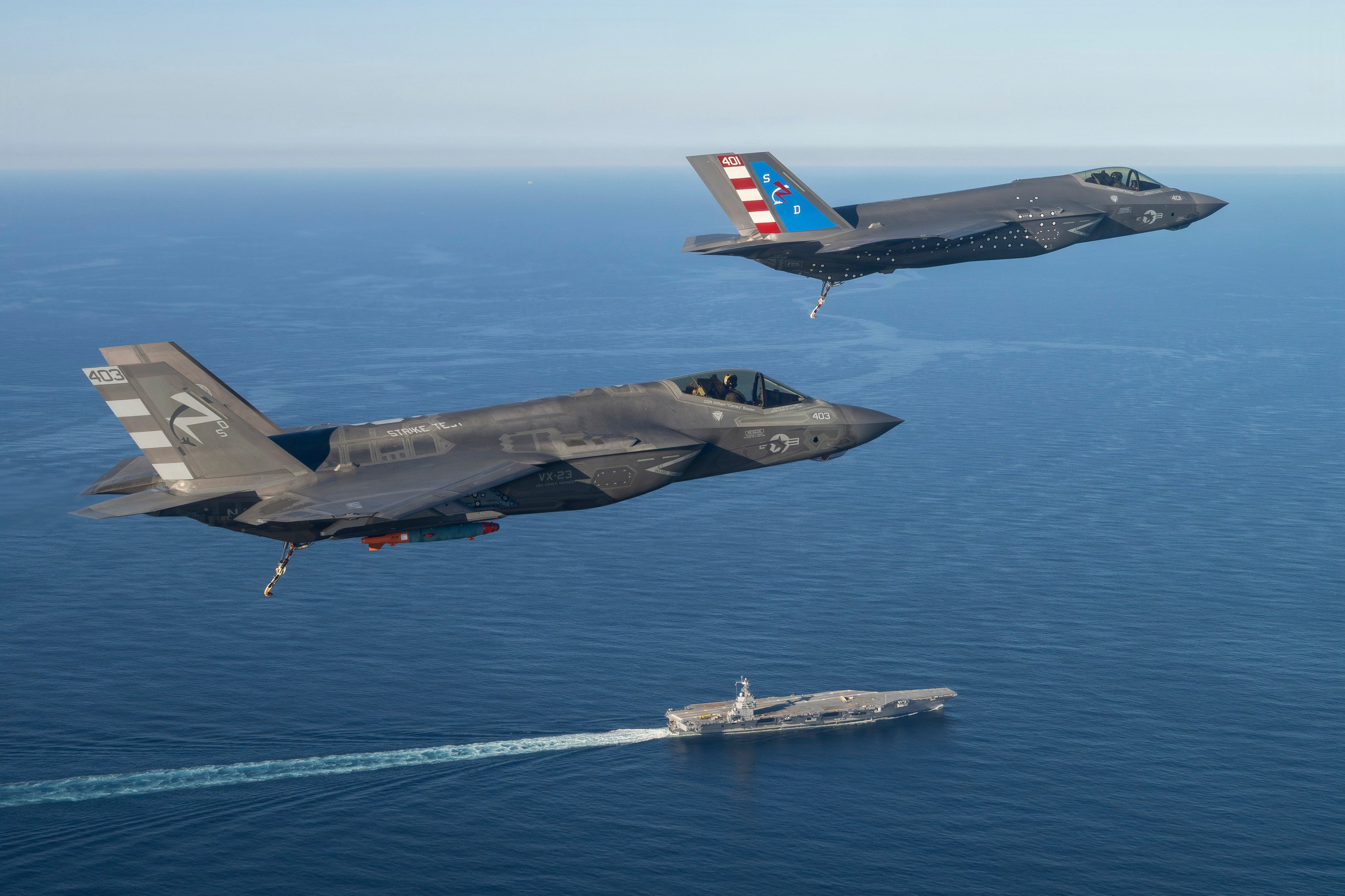 Two F-35 test pilots from Air Test and Evaluation Squadron Two Three (VX-23), Naval Air Warfare Center Aircraft Division (NAWCAD), fly F-35C Lightning II fighter aircraft to the PCU John F. Kennedy (CVN 79) in the Western Atlantic Oct. 13, 2026. This is the first time an F-35C has landed on a Ford-class aircraft carrier. A Patuxent River F-35 Integrated Test Force (ITF) team detached to the ship is conducting Aircraft Compatibility Testing (ACT) with the specially instrumented carrier variant of the stealth jet. ACT assesses the operational capabilities of the ship's aircraft launch and recovery equipment with U.S. Navy aircraft.