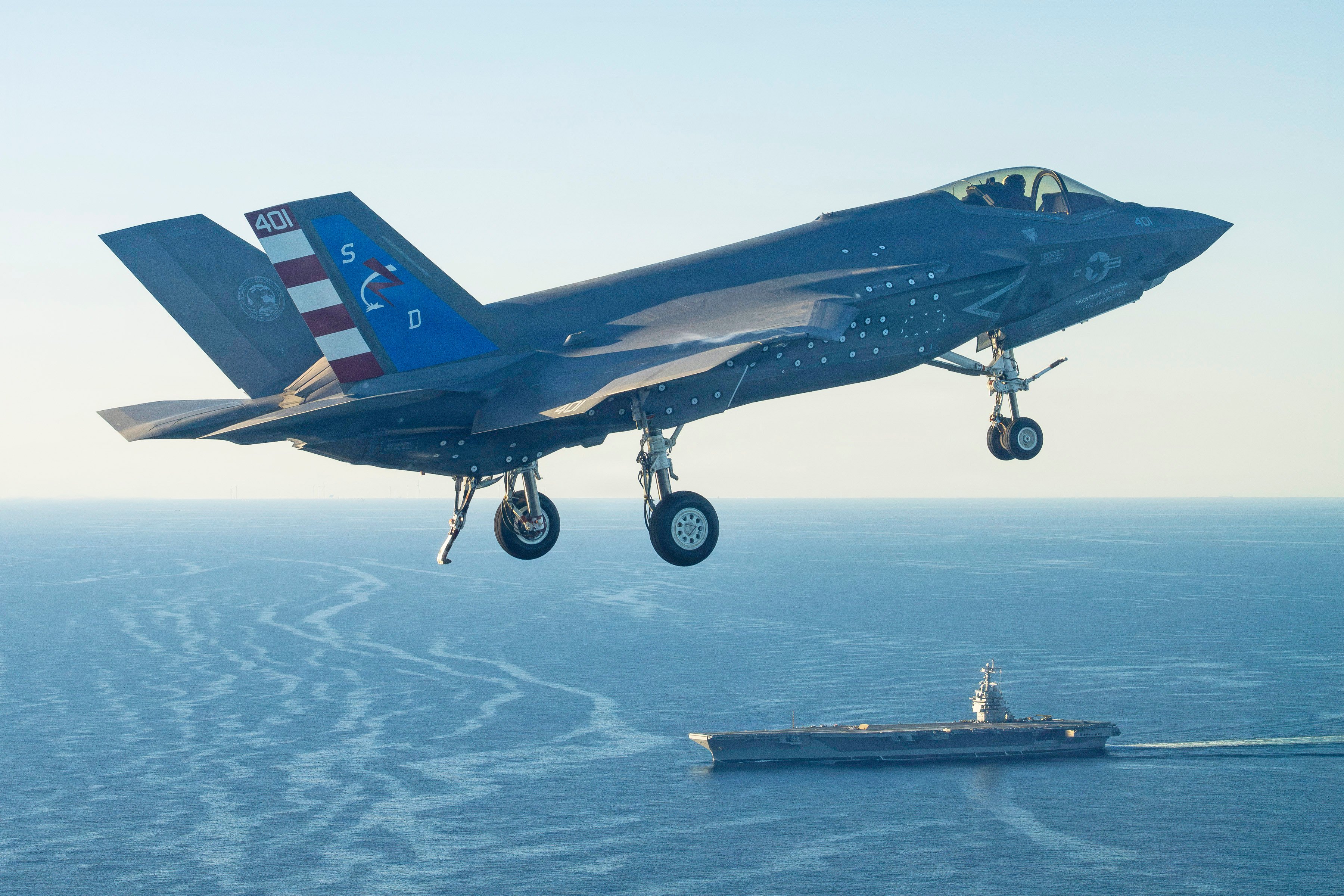 An F-35 test pilot from Air Test and Evaluation Squadron Two Three (VX-23), Naval Air Warfare Center Aircraft Division (NAWCAD), flies an F-35C Lightning II fighter aircraft to the PCU John F. Kennedy (CVN 79) in the Western Atlantic Oct. 13, 2026. This is the first time an F-35C has landed on a Ford-class aircraft carrier. A Patuxent River F-35 Integrated Test Force (ITF) team detached to the ship is conducting Aircraft Compatibility Testing (ACT) with the specially instrumented carrier variant of the stealth jet. ACT assesses the operational capabilities of the ship's aircraft launch and recovery equipment with U.S. Navy aircraft.