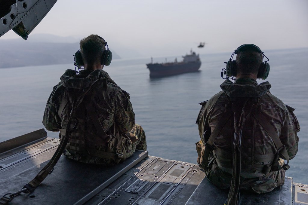 U.S. Navy Adm. Brad Cooper, commander of U.S. Central Command (left), and U.S. Army Maj. Gen. Brandon Tegtmeier, 82nd Airborne Division commander (right), observes commercial traffic transiting the Strait of Hormuz while flying over the international waterway in a U.S. Army CH-47 Chinook, Oct. 25, 2026. (U.S. Central Command photo)
