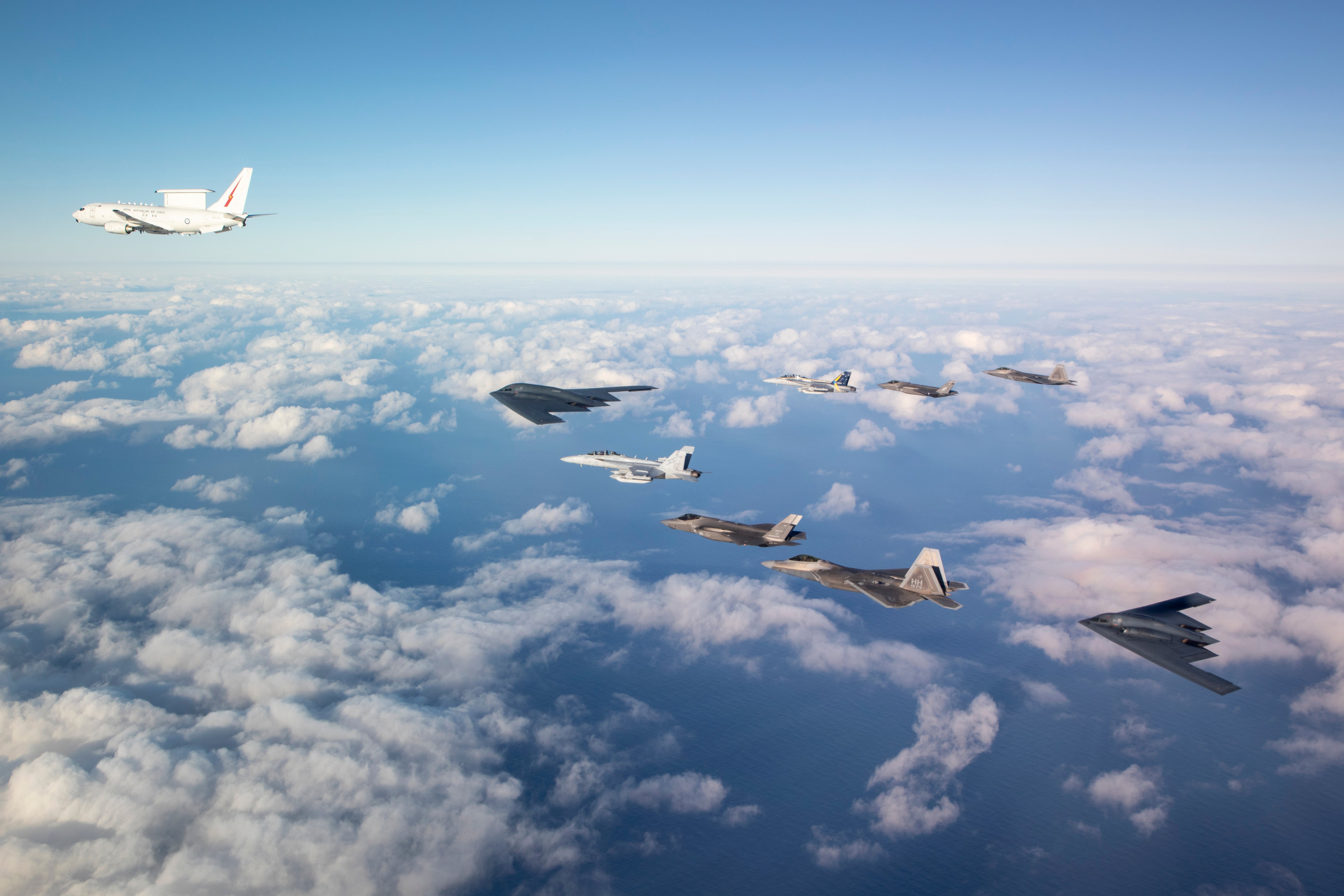 A Royal Australian Air Force E-7A Wedgetail, two EA-18G Growler jets and two F-35A Lightning II aircraft fly in formation with two United States Air Force B-2 Bombers and two F-22 Raptor fighter jets. *** Local Caption *** A Bomber Task Force consisting of United States Air Force B-2 Spirit stealth bombers, aviators and equipment from the 509th Bomb Wing and 131st Bomb Wing, are operating out of Royal Australian Air Force (RAAF) Base Amberley in Queensland. This deployment provides an opportunity for Australia and the United States to deepen air-to-air integration as part of the Enhanced Air Cooperation. RAAF and the United States Air Force have a longstanding shared history of military-to-military ties and regularly train together to improve interoperability.