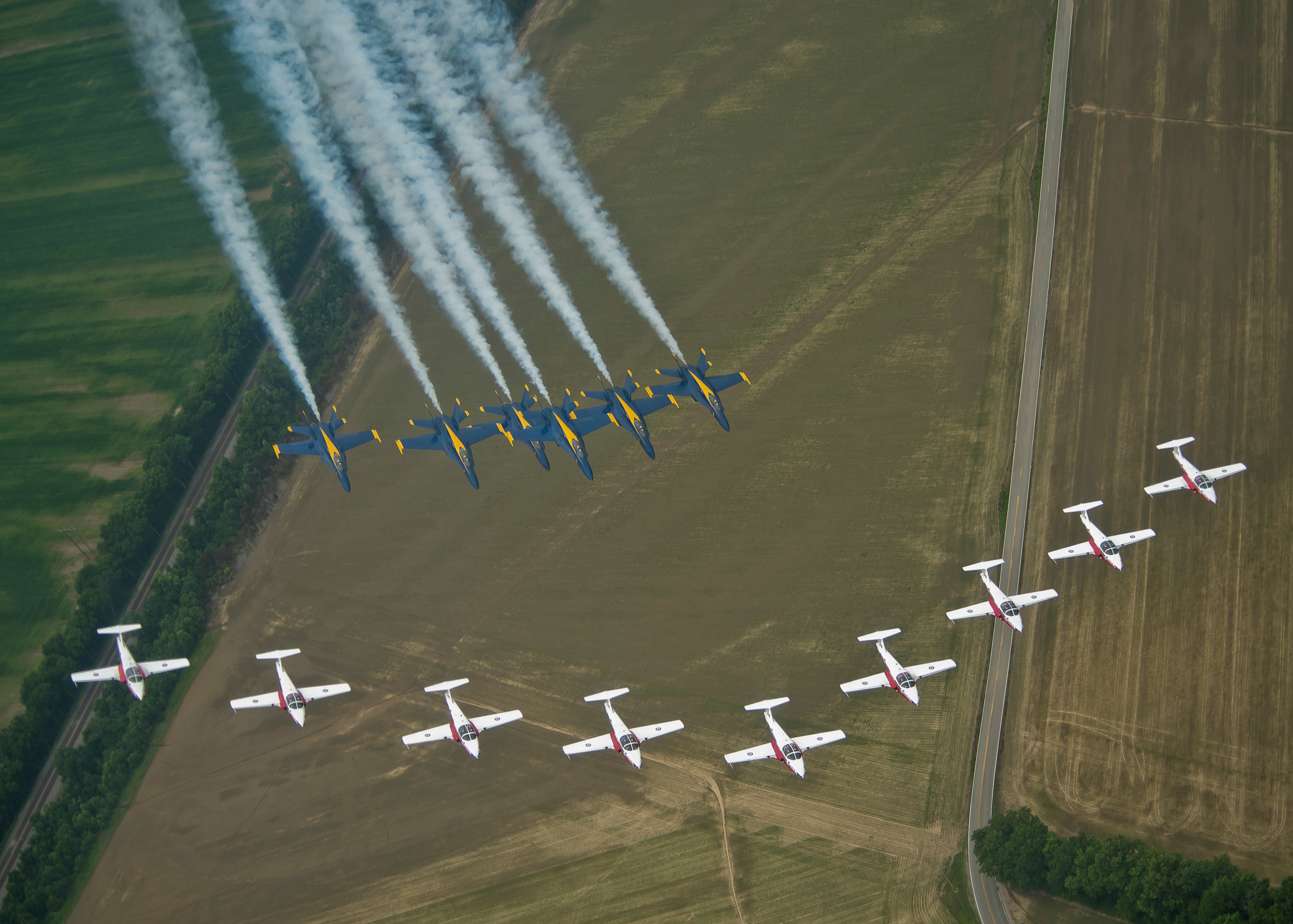 150625-N-SN160-356 EVANSVILLE, Ind. (Jun, 25, 2015) The U.S. Navy Flight Demonstration Squadron, the Blue Angels, join their signature Delta formation with the Canadian Air Demonstration Squadron, the Snowbirds, for a scheduled photo shoot over Evansville, Ind. The Blue Angels are scheduled to perform at 68 demonstrations at 35 locations across the U.S. in 2015.. (U.S. Navy photos by Mass Communication Specialist 1st Class Michael Lindsey/Released)
