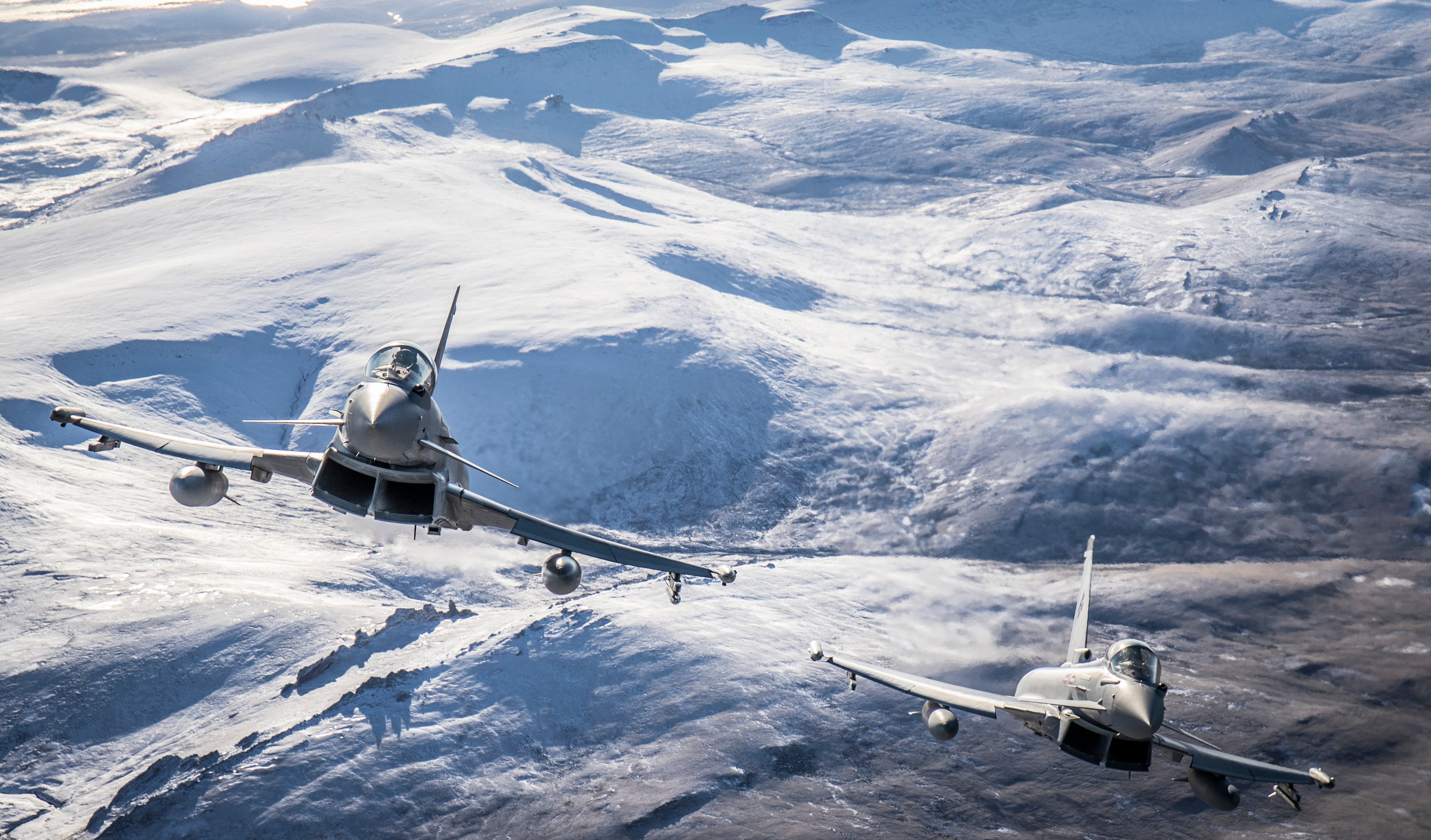 Pictured is a 1435 Flight Typhoon FGR4 pair flying over West Falkland island during a routine training flight. No 1435 Flight with their Typhoon FGR4's are currently based at Mount Pleasant The most recent purpose-built airfield in the RAF, Mount Pleasant was opened in 1985 to establish a fighter and transport presence in the Islands. The RAF provides key elements of the forces that Headquarters British Forces South Atlantic Islands use to ensure the security of the Falklands, the South Sandwich Islands and South Georgia. Not only through the air bridge from RAF Brize Norton to Ascension Island and onwards to the Falkland Islands, but also through deterrence patrols across the immense area between the islands.
