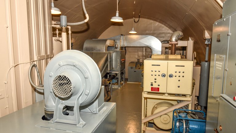 The interior of the launch control equipment room in the underground of the Oscar-1 Minuteman Missile Alert Facility on Whiteman Air Force Base, Missouri, June 18, 2020. The Oscar-01 MAF was constructed at Whiteman AFB in 1963 and determined to be eligible for the National Register of Historic Places (NRHP) by Missouri SHPO in 1998. The facility consists of a one-story surface structure, assembled as a Launch Control Support Building (LCSB), and two sub-surface, re-enforced concrete encapsulated steel pods- a Launch Control Center (LCC) and Launch Control Equipment Building (LCEB). These two sub-surface wings are connected by a Tunnel Junction and accessed by an elevator. (U.S. Air Force photo by Tech. Sgt. Alexander W. Riedel)