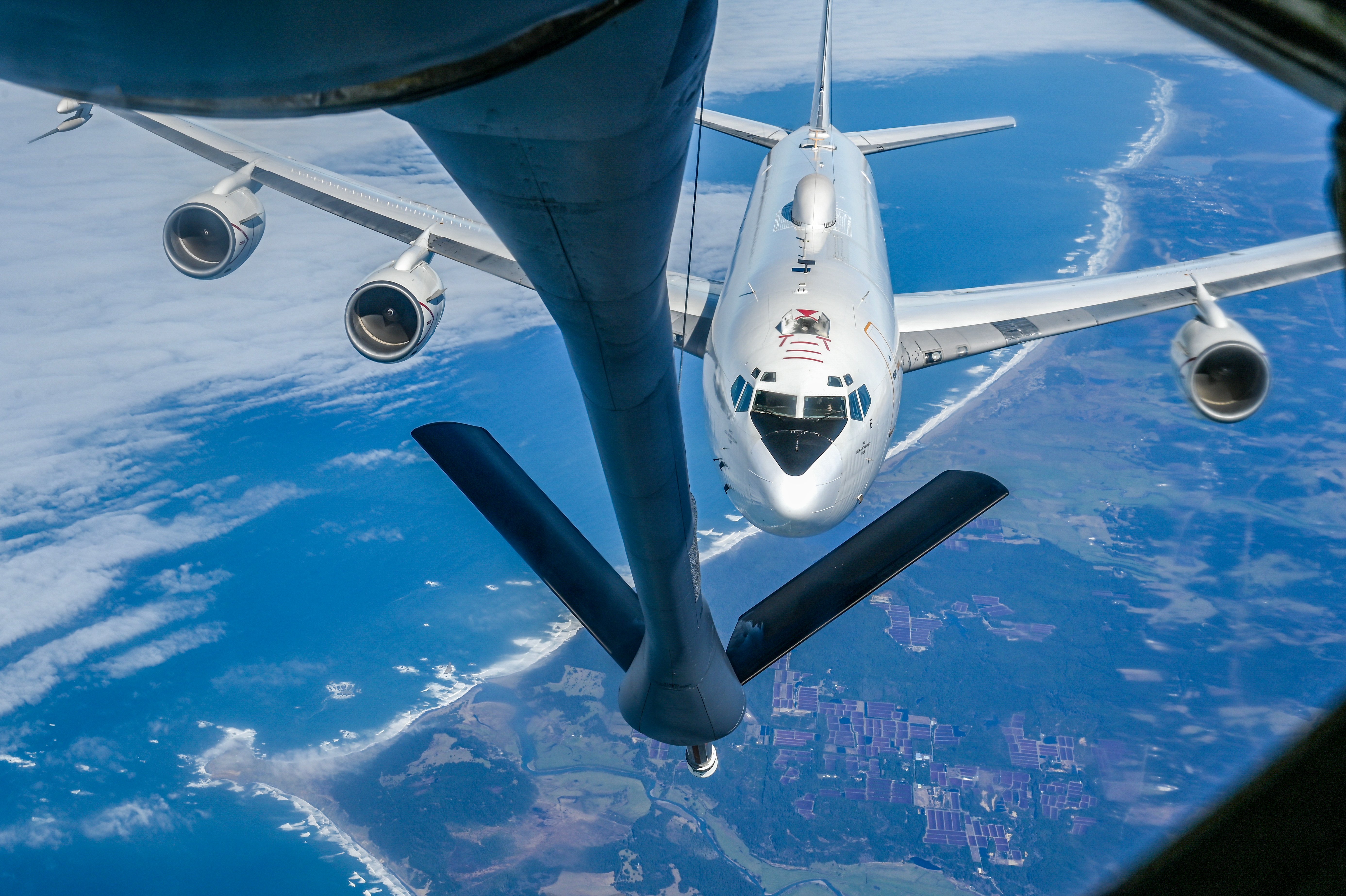 An E-6B Mercury assigned to the Strategic Communications Wing 1 at Tinker Air Force Base approaches a KC-135 Stratotanker assigned to the 92nd Air Refueling Wing during an aerial refueling mission over Oregon, Feb. 28, 2025. Aerial refueling capabilities are essential for strategic and tactical operations as well as humanitarian relief efforts in support of Air Mobility Command, U.S. Transportation Command and Department of Defense priorities. (U.S. Air Force photo by Airman 1st Class Megan Delaine)