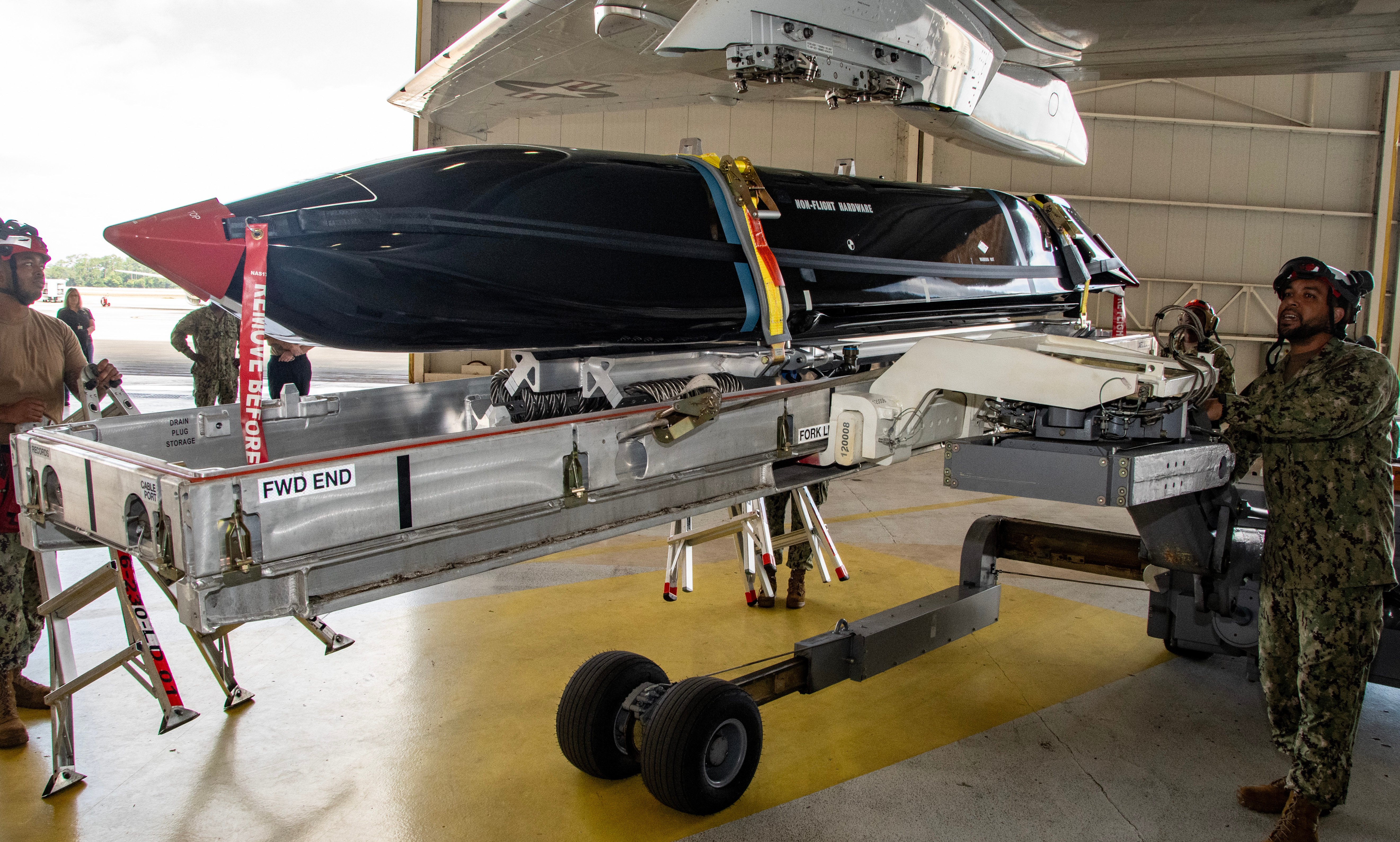 JACKSONVILLE, Fla. (October 1, 2025) Sailors assigned to Patrol Squadron (VP) 30 transport an AGM-158C Long Range Anti-Ship Missile (LRASM) using a Munition Handling Unit prior to installation on board a P-8A Poseidon maritime patrol aircraft, October 1, 2025. VP-30’s mission is to provide P-8A and MQ-4C Triton Unmanned Aircraft System (UAS) specific training to pilots, Naval flight officers, and enlisted aircrew prior to reporting to the fleet. (U.S. Navy photo by Mass Communication Specialist 1st Class Curtis D. Spencer.)