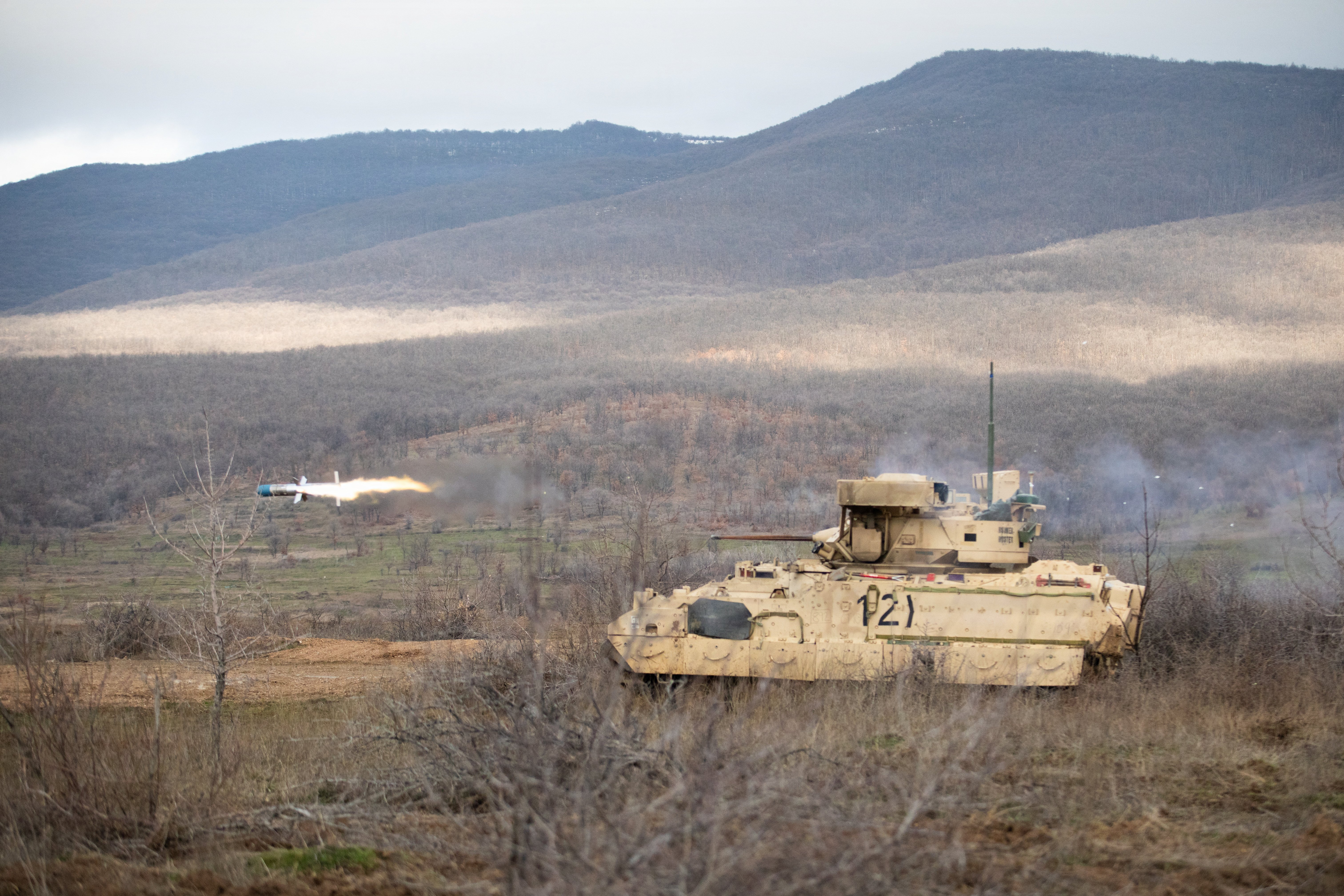 An M2A3 Bradley Infantry Fighting Vehicle with Headquarters and Headquarters Company, 1st Battalion, 16th Infantry Regiment, 1st Armored Brigade Combat Team, 1st Infantry Division, uses a twin-tube, turret-mounted launcher to fire a BGM-71 Tube-launched, Optically-tracked, Wireless-guided (TOW) anti-tank missile, Feb. 25, 2026, on Novo Selo Training Area, Bulgaria. The training focused on developing individual crews, target engagement skills and maneuverability. Live-fire exercises increase the lethality of crews on various weapons systems while generating warfighting readiness and combat credible forces along NATO’s Eastern Flank. (U.S. Army photo by Spc. Brandi Frizzell)