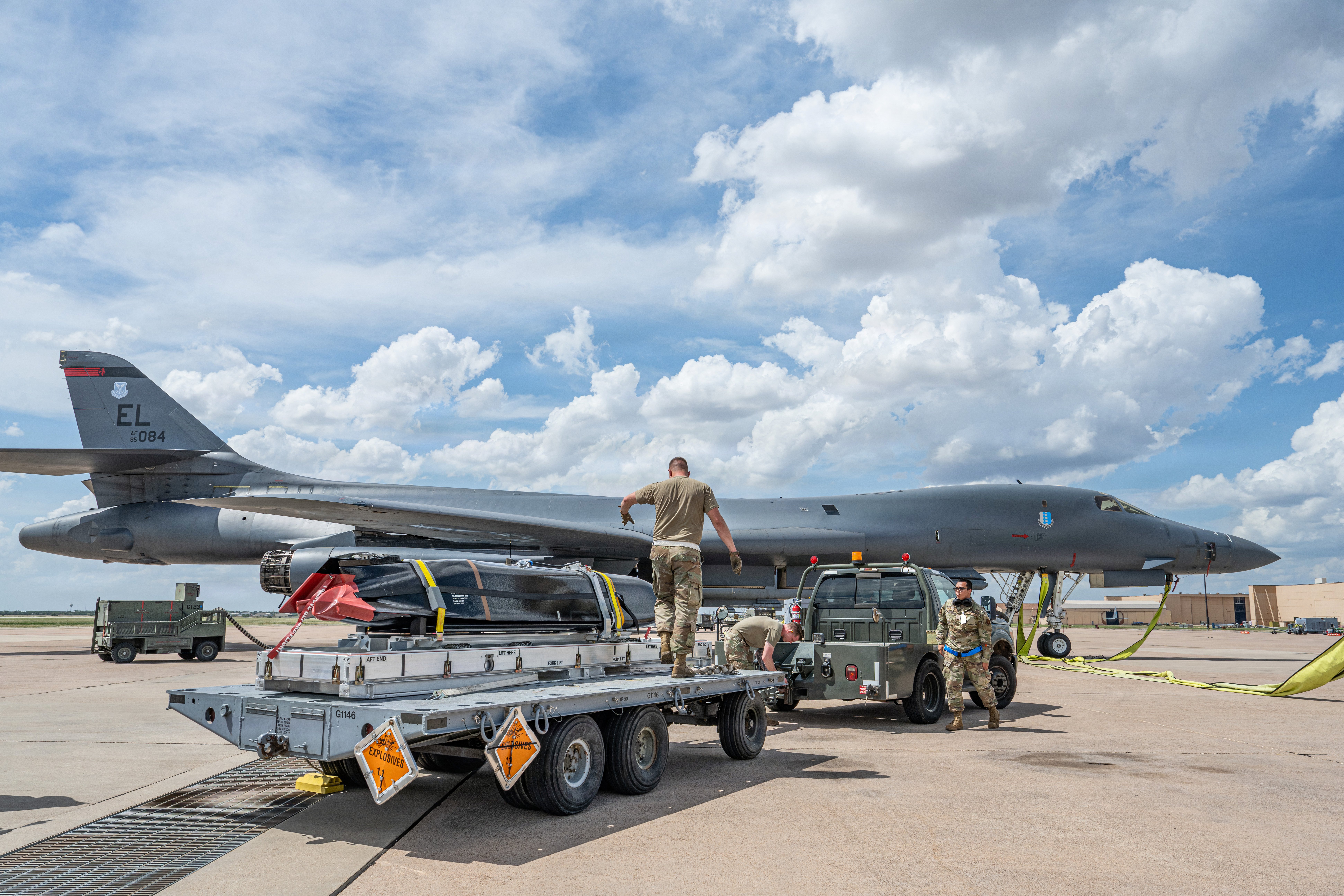 U.S. Airmen transport a live AGM-158C Long Range Anti-Ship Missile toward a B-1B Lancer during a U.S. Air Force LRASM Event Zero at Dyess Air Force Base, Texas, June 2, 2026. Led by the 7th Bomb Wing, the event focused on validating critical pre-flight procedures by connecting the munition to the aircraft using a locally fabricated cable. The effort helped evaluate processes supporting future weapon integration and maritime strike capabilities. (U.S. Air Force photo by Airman 1st Class Caleb Schellenberg)