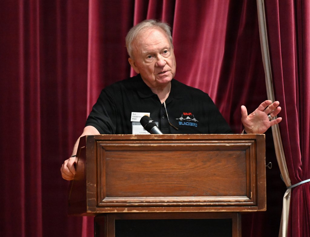 U.S. Air Force Col. (ret.) Buz Carpenter, former SR-71 Blackbird instructor pilot, shares some of his memories of flying the supersonic aircraft with the audience at RAF Mildenhall, England, July 27, 2026. Carpenter and other SR-71 veteran pilots, aircrew and maintainers, along with their family members, received mission briefings and a tour of the base, including hangars where they once worked, and static displays. The Blackbird was assigned to Detachment 4, 9th Reconnaissance Wing, out of RAF Mildenhall from 1976 to 1990, and 2026 marks the 50th anniversary of its arrival here. (U.S. Air Force photo by Karen Abeyasekere)