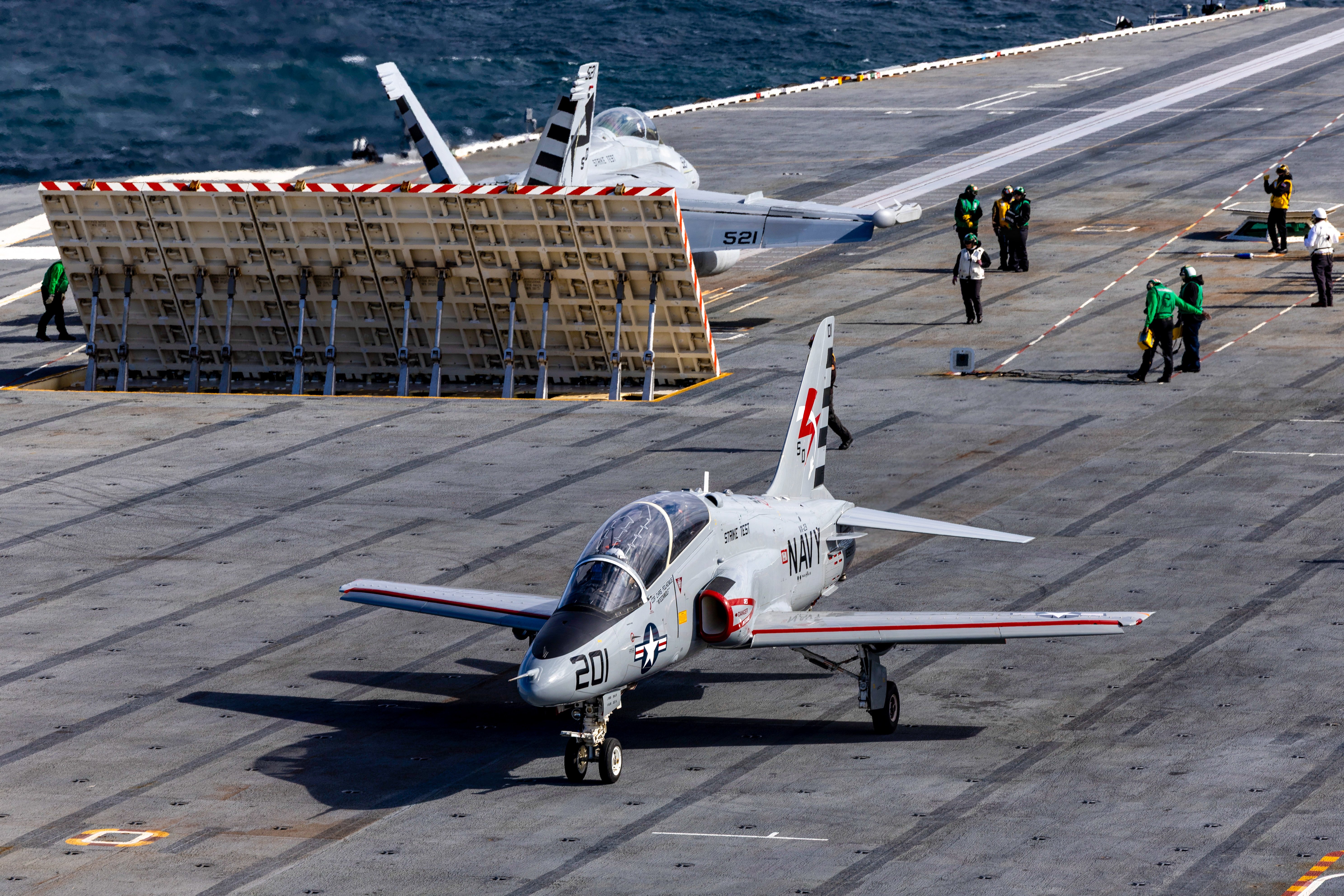 A T-45C Goshawk, left, and an EA-18G Growler, both attached to the 
