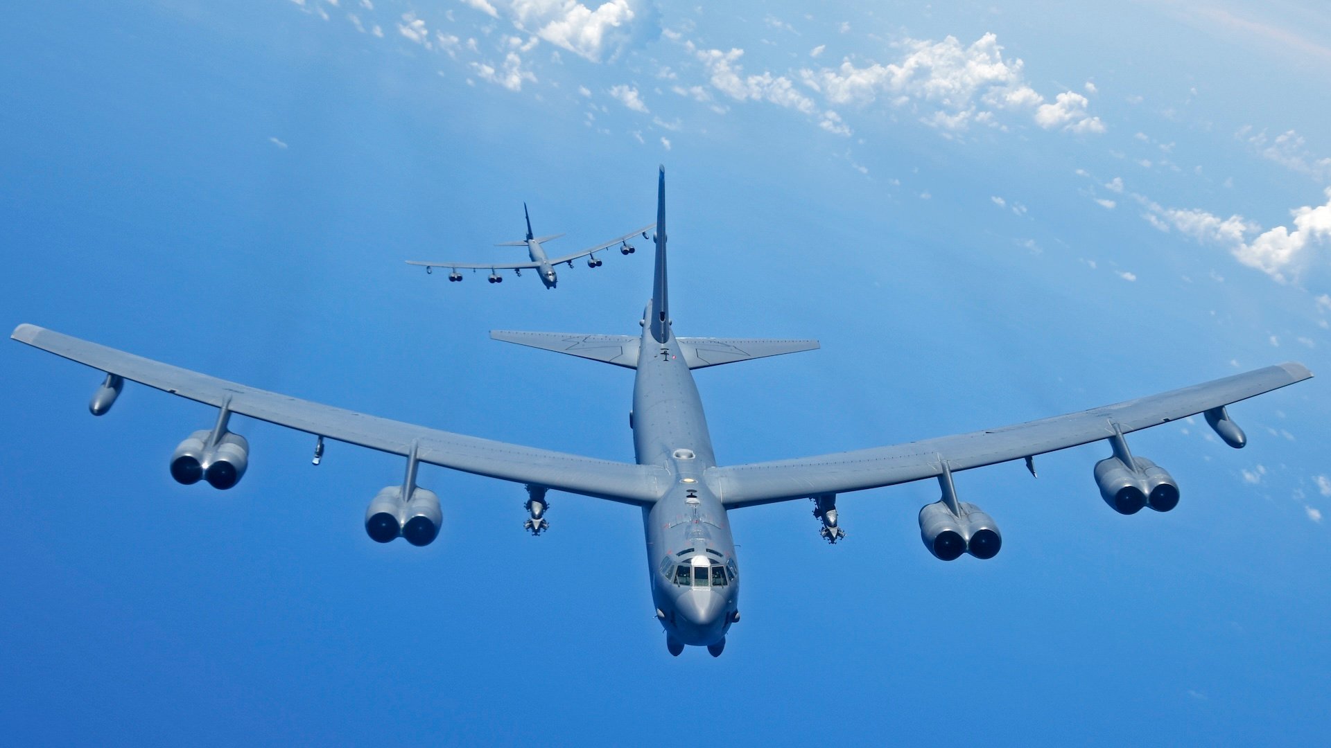 Two U.S. Air Force B-52H Stratofortress bombers fly over the Pacific Ocean during a routine training mission Aug. 2, 2018. This mission was flown in support of U.S. Indo-Pacific Command’s Continuous Bomber Presence operations, which are a key component to improving combined and joint service interoperability. (U.S. Air Force photo by Airman 1st Class Gerald R. Willis)