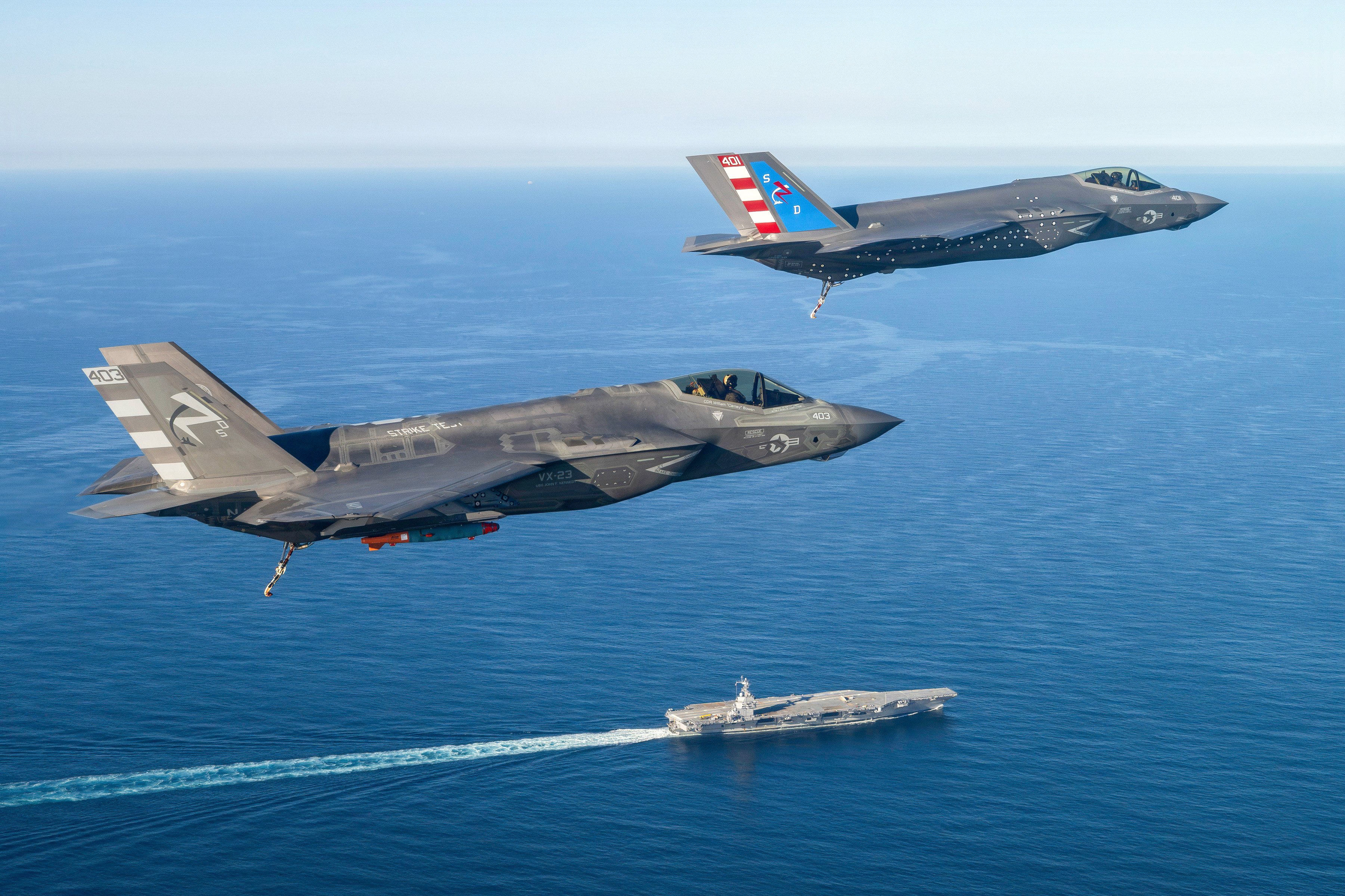 Two F-35 test pilots from Air Test and Evaluation Squadron Two Three (VX-23), Naval Air Warfare Center Aircraft Division (NAWCAD), fly F-35C Lightning II fighter aircraft to the PCU John F. Kennedy (CVN 79) in the Western Atlantic Oct. 13, 2026. This is the first time an F-35C has landed on a Ford-class aircraft carrier. A Patuxent River F-35 Integrated Test Force (ITF) team detached to the ship is conducting Aircraft Compatibility Testing (ACT) with the specially instrumented carrier variant of the stealth jet. ACT assesses the operational capabilities of the ship's aircraft launch and recovery equipment with U.S. Navy aircraft.