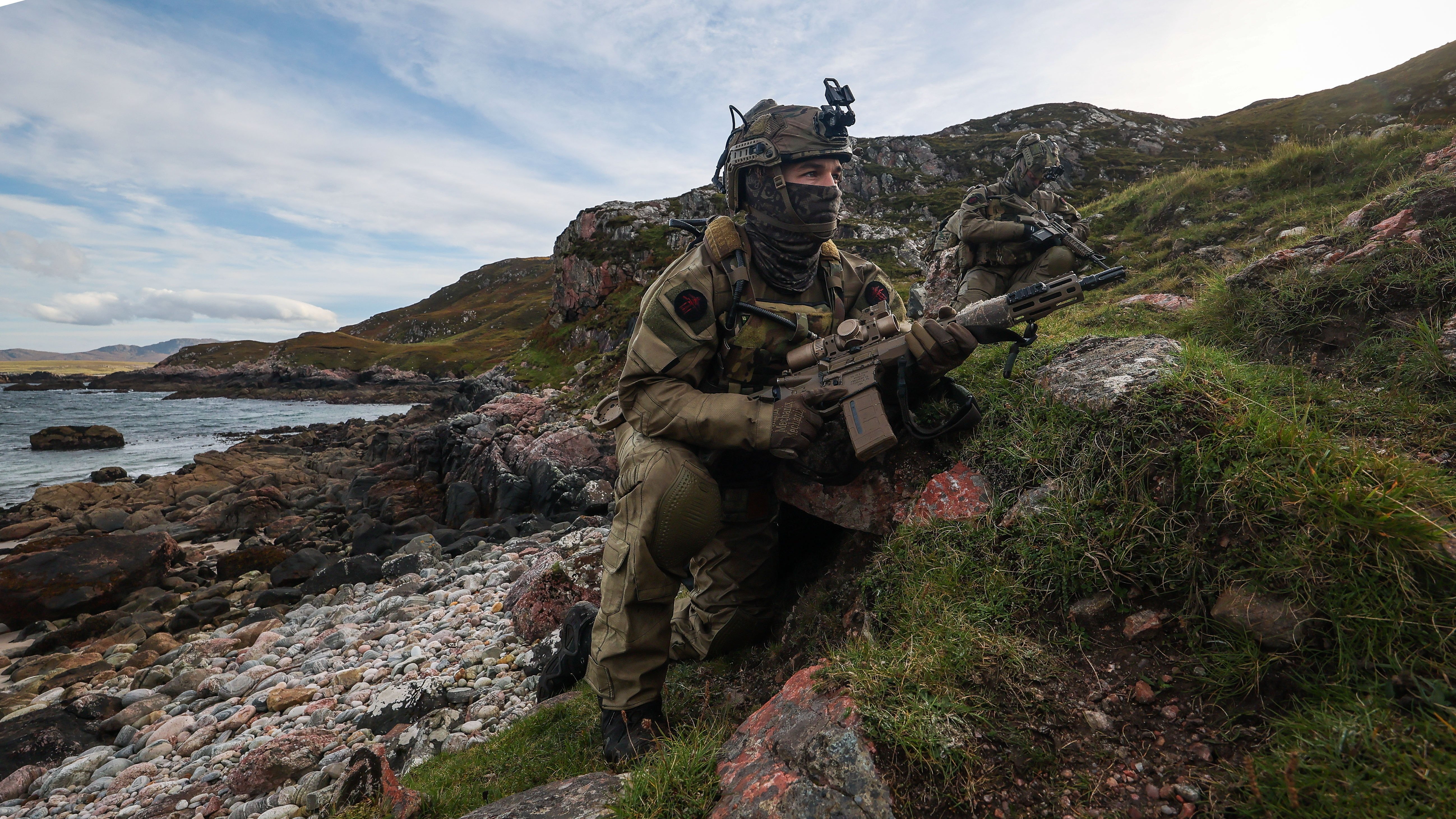29 Sep 2026 – 148 Battery secure a remote beach in Cape Wrath. 148 (Meiktila) Commando Forward Observation Battery has conducted a Full Mission Profile (FMP), integrating a German Navy submarine and Portuguese warship during Exercise Strike Warrior 26. The serial was designed to rehearse a submarine link-up and develop the Battery’s maritime integration, including float-on/float-off drills with 148’s boats. The force subsequently conducted a submarine infiltration and discreet small-boat insertion towards the target area. The FMP culminated in the establishment of an Observation Post (OP), from which the team coordinated live Naval Surface Fires from the Portuguese warship, resulting in a successful engagement and extraction. The serial demonstrated the capability of NATO partners to integrate specialist assets and coordinate complex activity across the maritime and land domains. The submarine provided Intelligence, Surveillance and Reconnaissance (ISR) support to identify and develop the target, before deploying Special Observation Teams to conduct a tactical beach landing and establish a hasty OP. The Portuguese warship subsequently delivered live Naval Surface Fires against the designated target. “This level of complexity and coordination of live assets has not been achieved by 148 for nearly 30 years. We wanted to demonstrate to our partners across the United Kingdom Commando Force, wider UK Defence and NATO SOF community the type of missions we are prepared to execute against future threats. Warfighting is our focus, and we are prepared to employ specialist assets to deliver Multi-Domain Fires and Targeting.” - Operations Officer, 148 (Meiktila) Commando Forward Observation Battery, Royal Artillery. The UK Commando Force are taking part in their largest collective workout in 15 years to demonstrate their ability to safeguard the country – and its allies – against a myriad of threats.