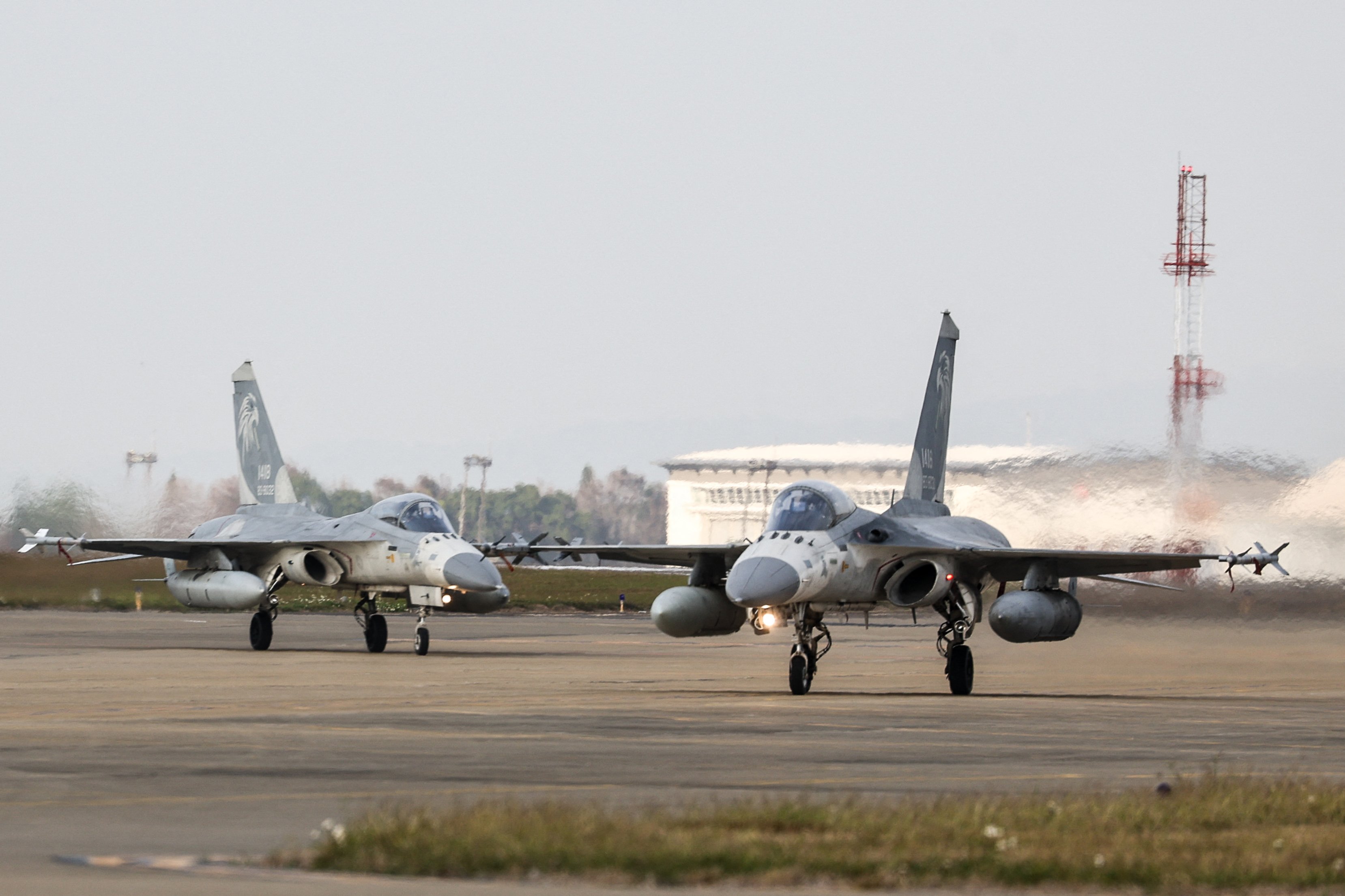 TOPSHOT - Taiwanese air force Indigenous Defense Fighter aircraft taxi for take-off during a scramble as part of a combat readiness exercise at the Ching Chuan Kang Air Base in Taichung on January 7, 2025. (Photo by I-HWA CHENG / AFP) (Photo by I-HWA CHENG/AFP via Getty Images)