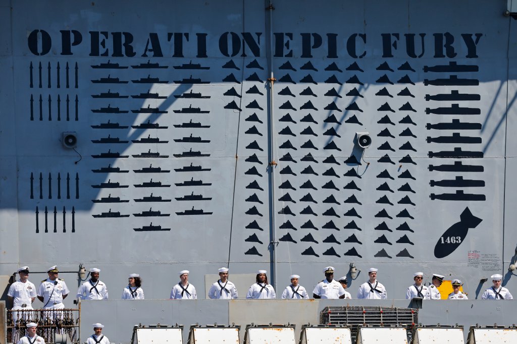 CORONADO, CALIFORNIA - OCTOBER 08: Sailors aboard the USS Abraham Lincoln Nimitz-class aircraft carrier look on as the ship docks at its homeport at Naval Air Station North Island on return from a historic 10-month deployment on October 8, 2026 in Coronado, California. The USS Abraham Lincoln (CVN 72) set a U.S. Navy record spending over 260 days consecutively at sea without a port call while playing a key role in Operation Epic Fury and regional maritime security operations in the Middle East. (Photo by Mario Tama/Getty Images)