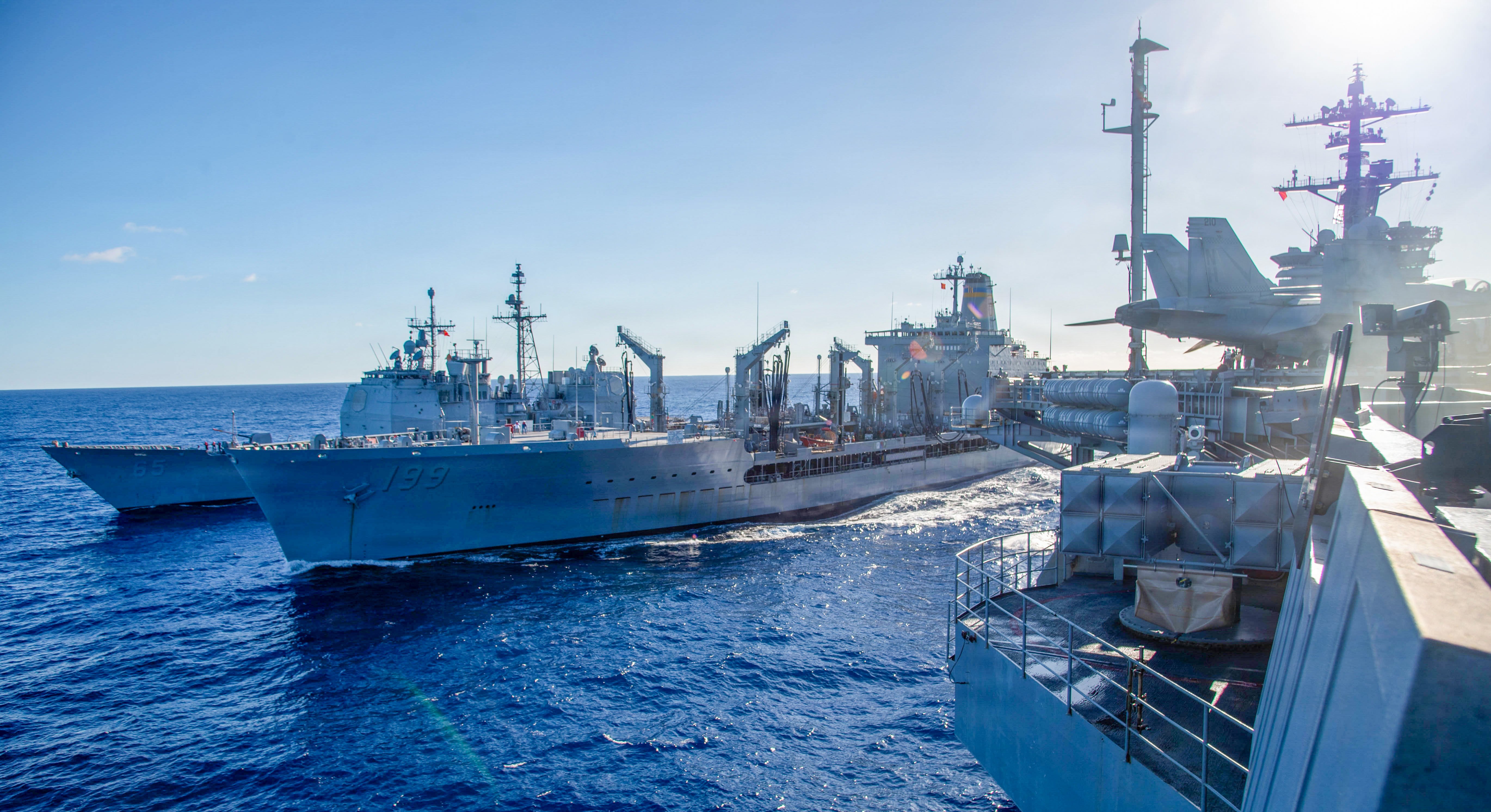 Ticonderoga-class guided-missile cruiser USS Chosin (CG 65), left, pulls alongside Henry J. Kaiser-class fleet replenishment oiler USNS Tippecanoe (T-AO 199), middle, and Nimitz-class aircraft carrier USS Theodore Roosevelt (CVN 71), during a replenishment-at-sea Oct. 6, 2026. Theodore Roosevelt, flagship of Carrier Strike Group (CSG) 9, is underway conducting routine operations in the U.S. 3rd Fleet area of operations, demonstrating the U.S. Navy’s commitment to a free and open Indo-Pacific. (U.S. Navy Photo by Mass Communication Specialist Seaman Gary Buckles)